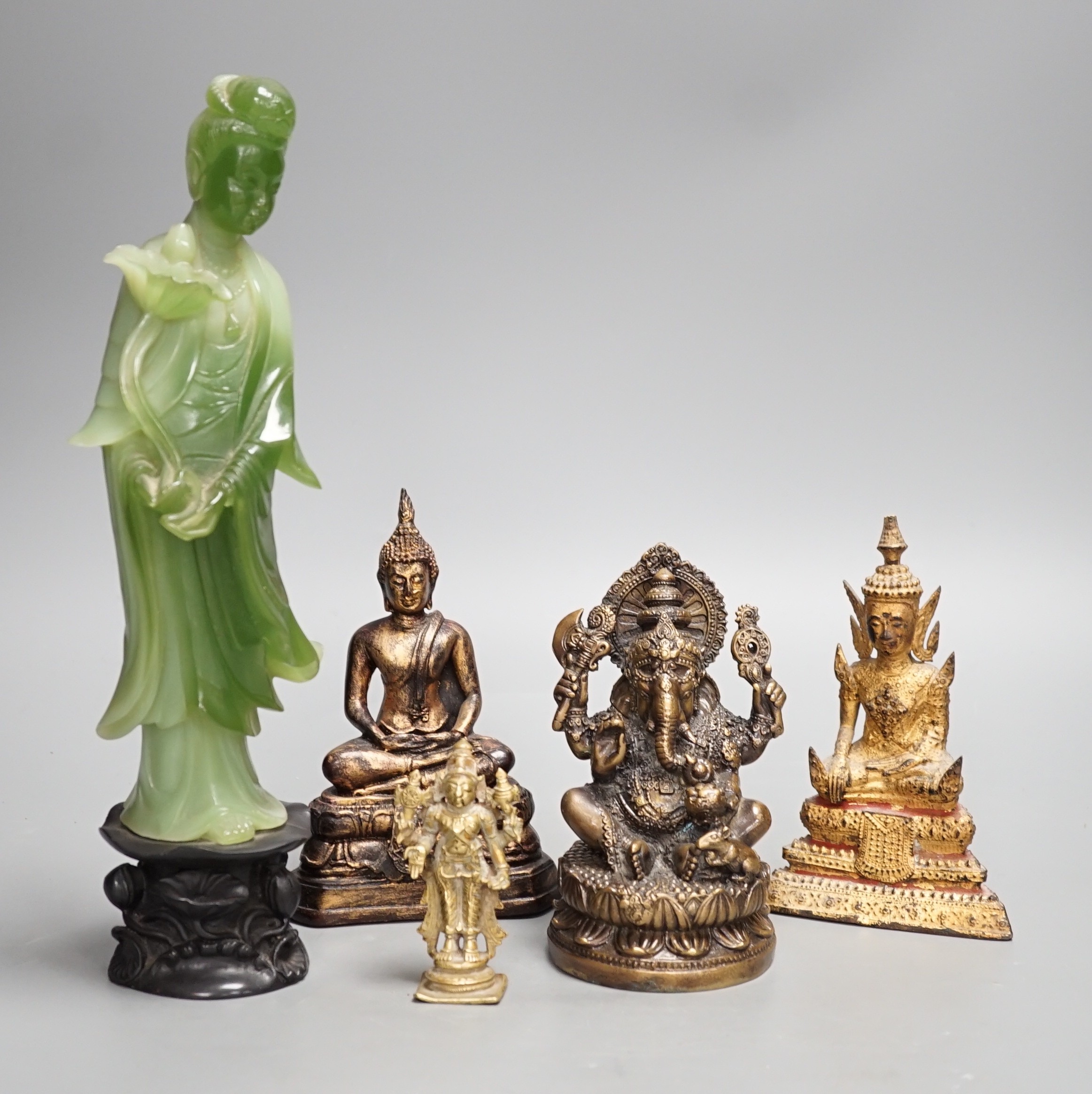 A Thai gilt resin model of Buddha, an Indian bronze model of Ganesh, a jadeite coloured carving of Guanyin and two other figures. Tallest 30cm